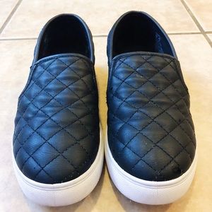 Steve Madden Black quilted slip on shoes.